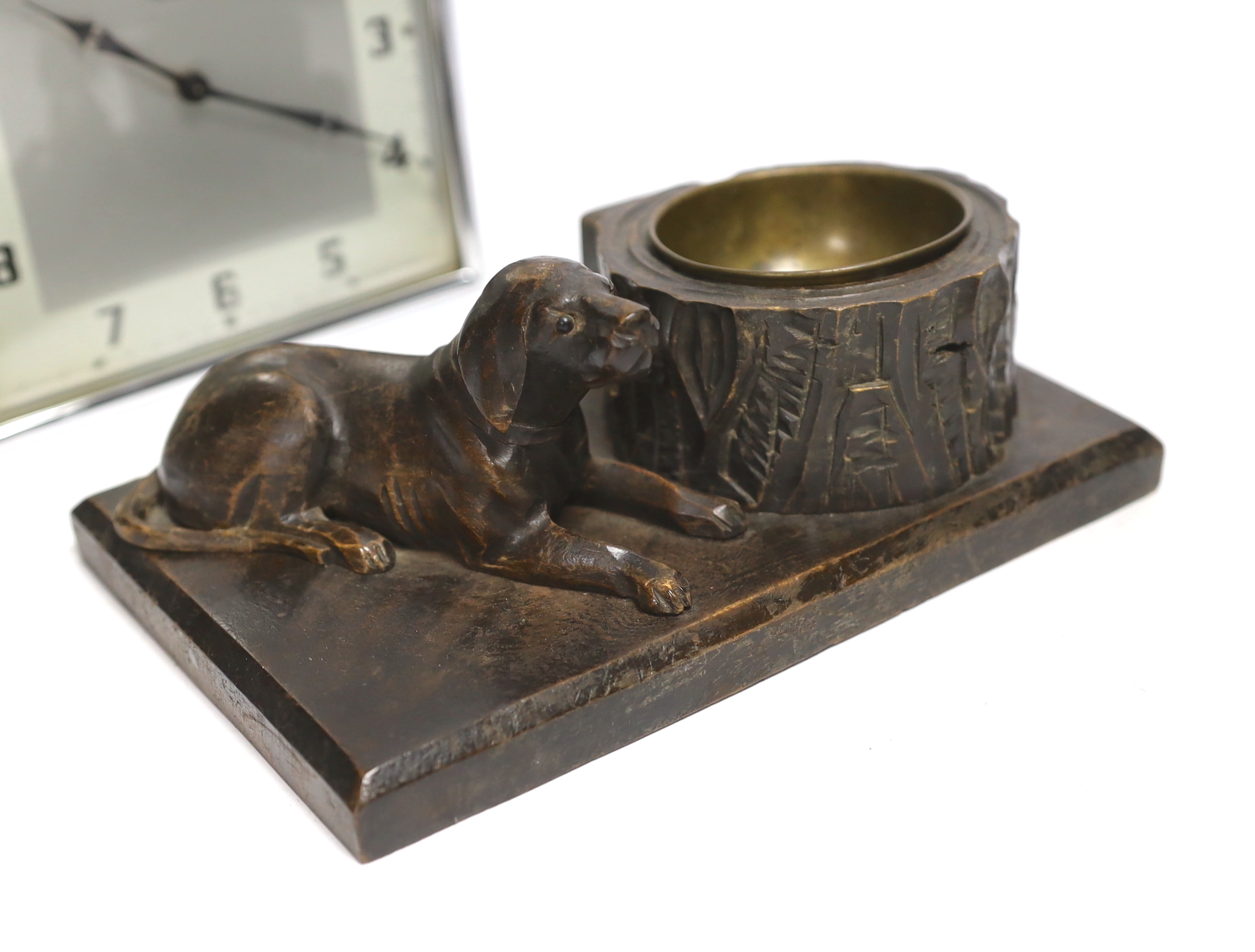 Two Art Deco clocks and two carved wood ‘dog’ ash trays, tallest 18cm
